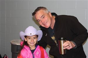 Father with daughter wearing cowboy hat 